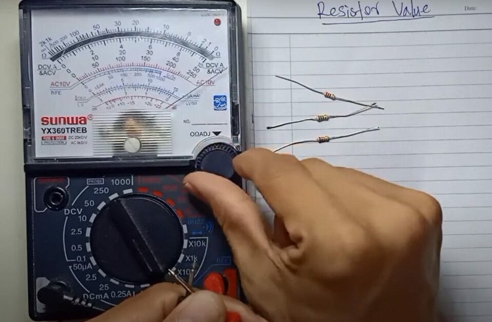 A person is using a multimeter to test voltage and resistance