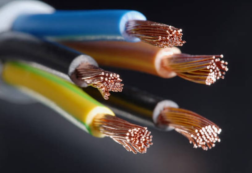 A close up of several different colored wires with stripped tips