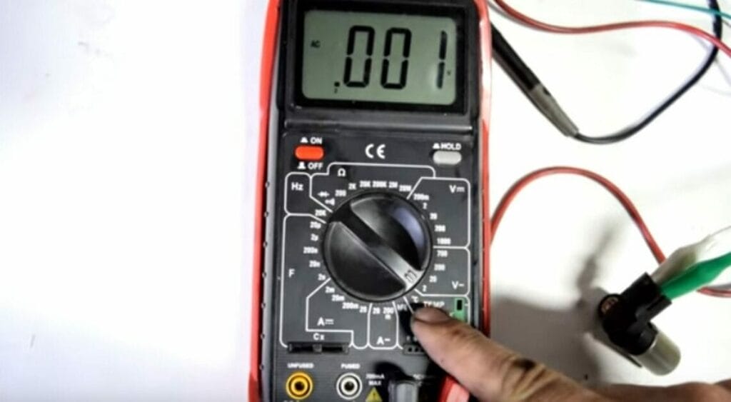 A person setting the multimeter to AC voltage