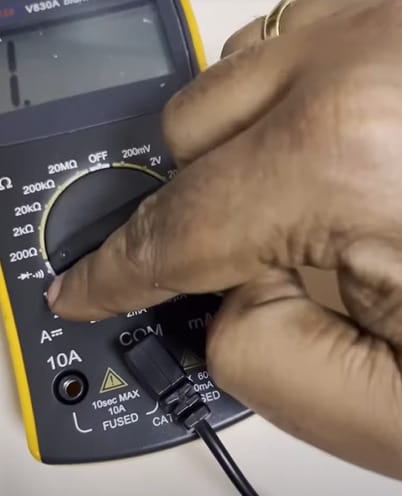 A person is setting the multimeter