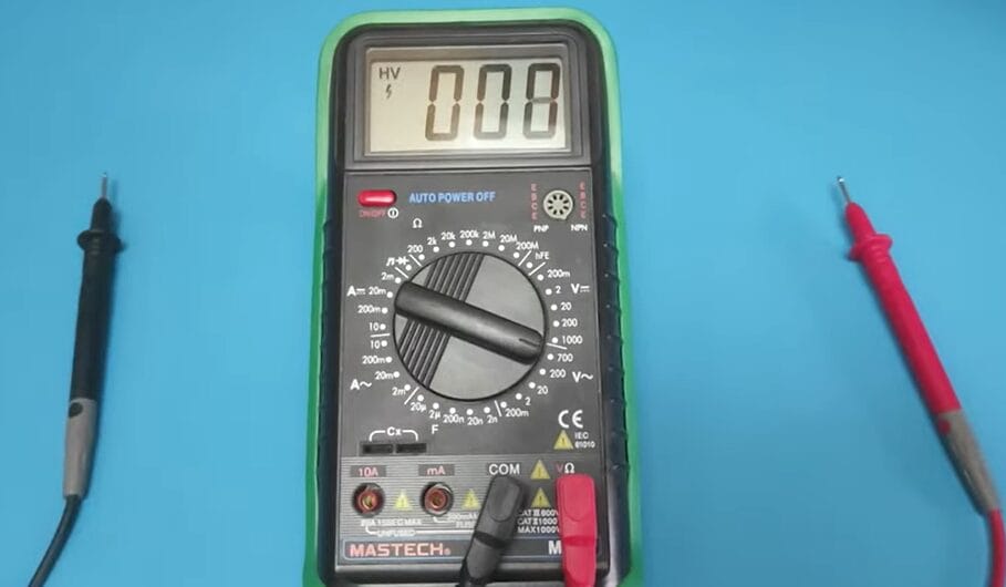 A multimeter with two wires next to it, demonstrating how to check 240 voltage.