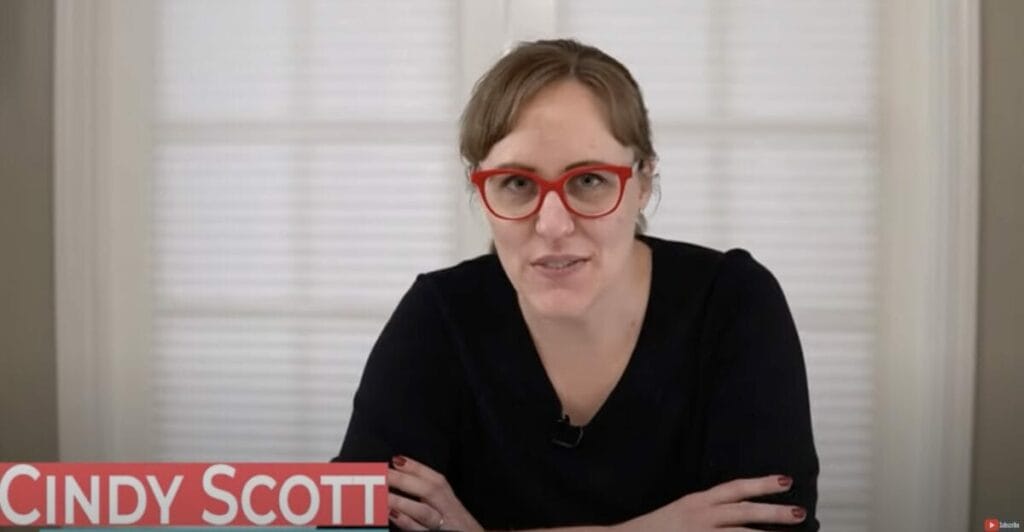 Cindy Scott's interview with a woman wearing glasses about installing window blinds without drilling.