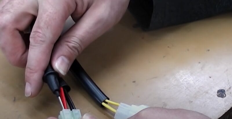 A person is using a multimeter to test a rectifier