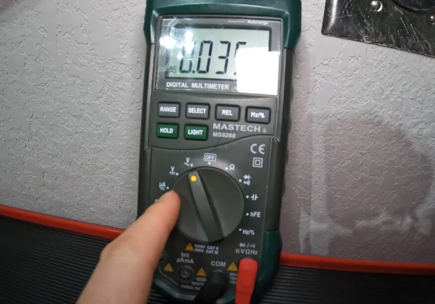 A person setting up the multimeter for testing