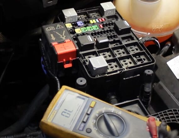 A car fuse box equipped with a multimeter for testing purposes