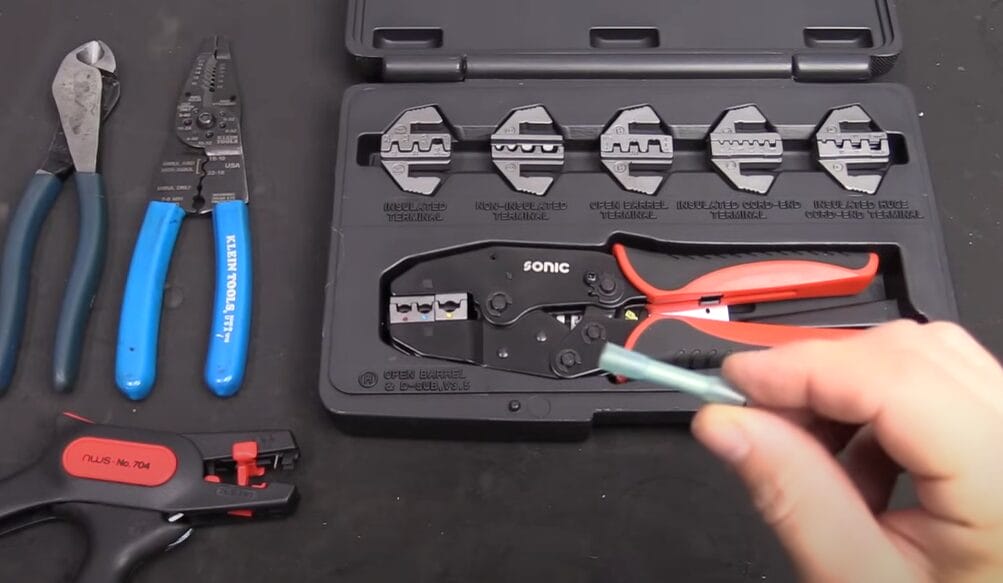 A person is holding a set of pliers in a case