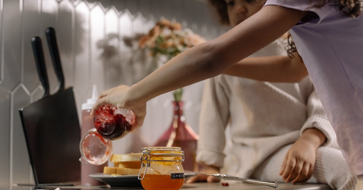 little girls preparing jam sandwiches