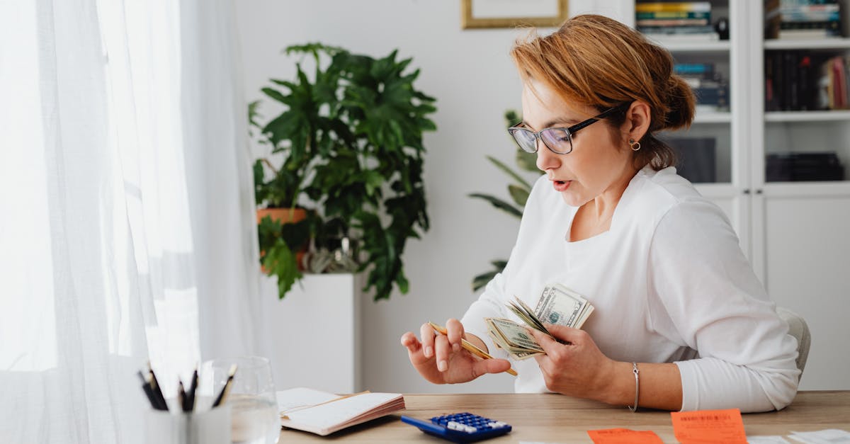 woman sitting at desk counting money