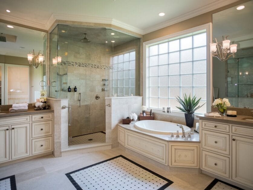 Spacious bathroom at The Red Oak Retreat featuring a glass-enclosed shower, a large bathtub, double vanities, and ample natural light from a frosted window in this 3,500 Sq. Ft. modern farmhouse.