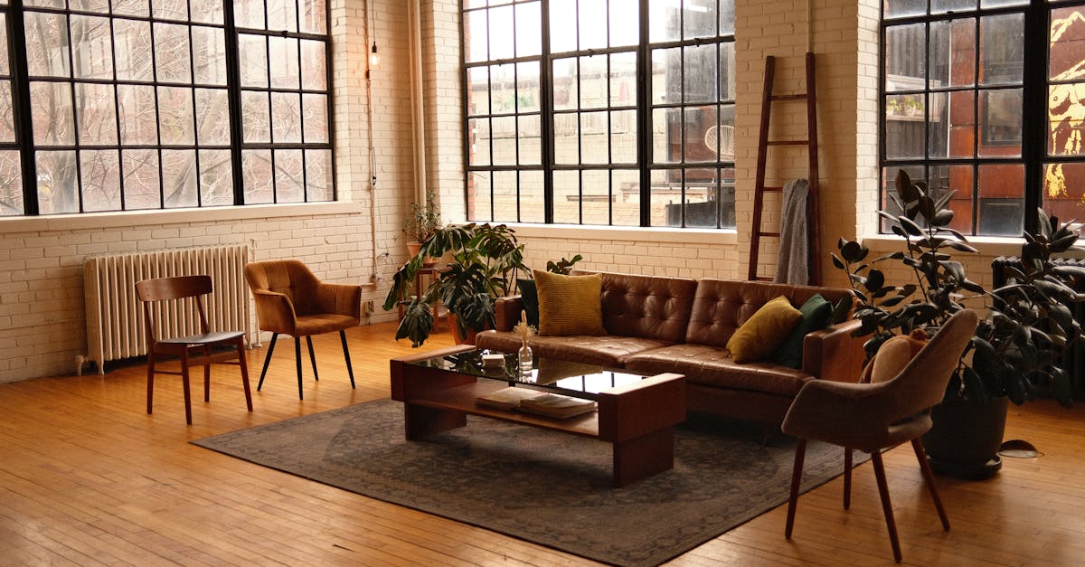 spacious loft style living room with modern furniture large windows and warm lighting