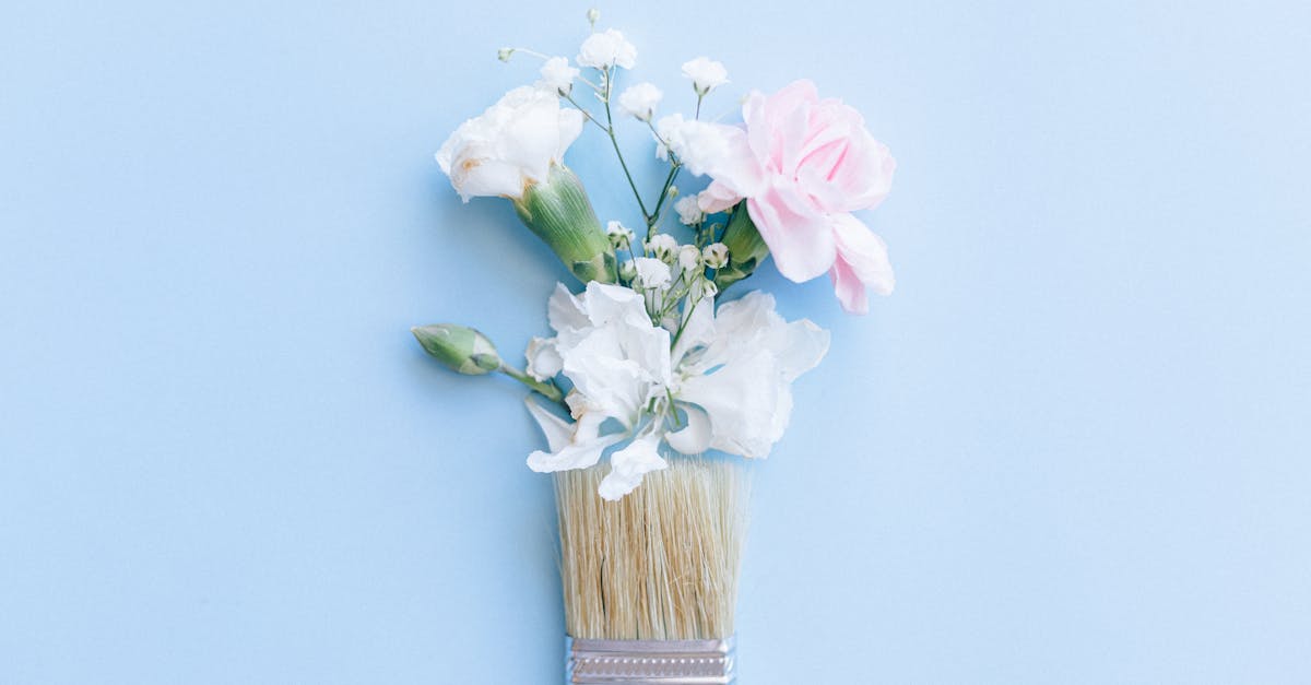 artistic floral arrangement in a paintbrush on a light blue background perfect for creative design