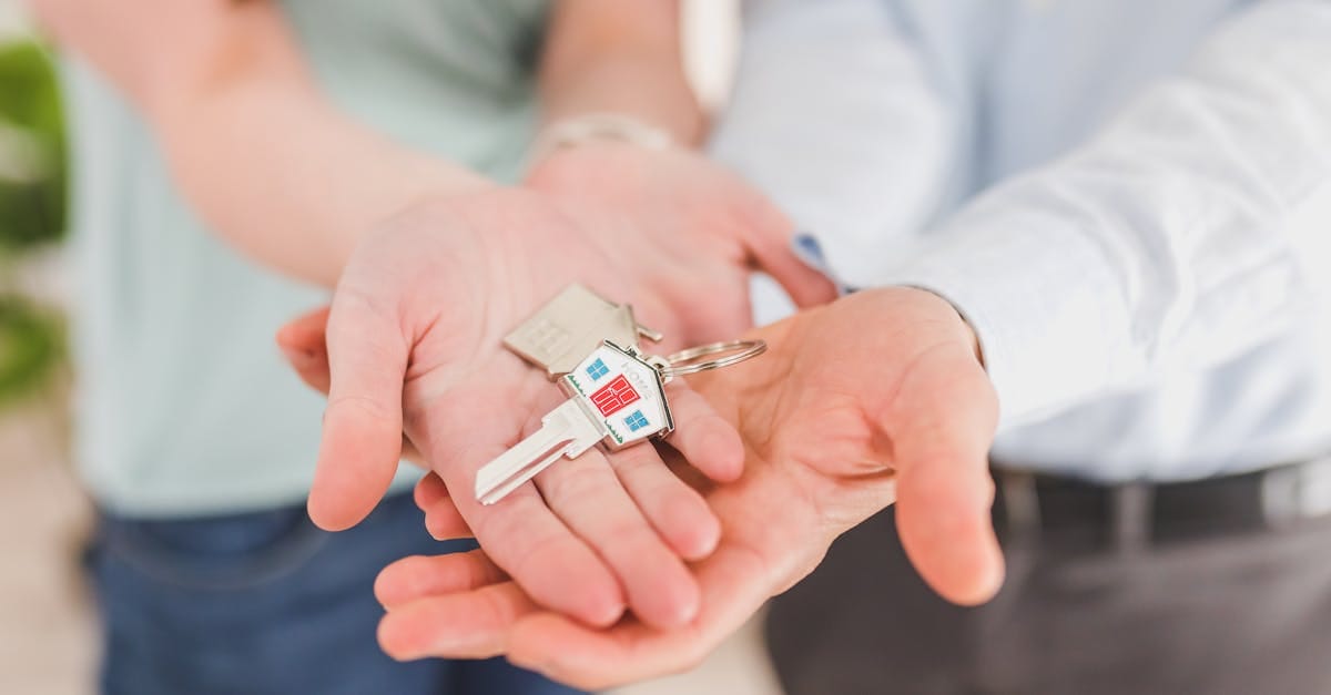 close up of a couple holding keys symbolizing homeownership and investment