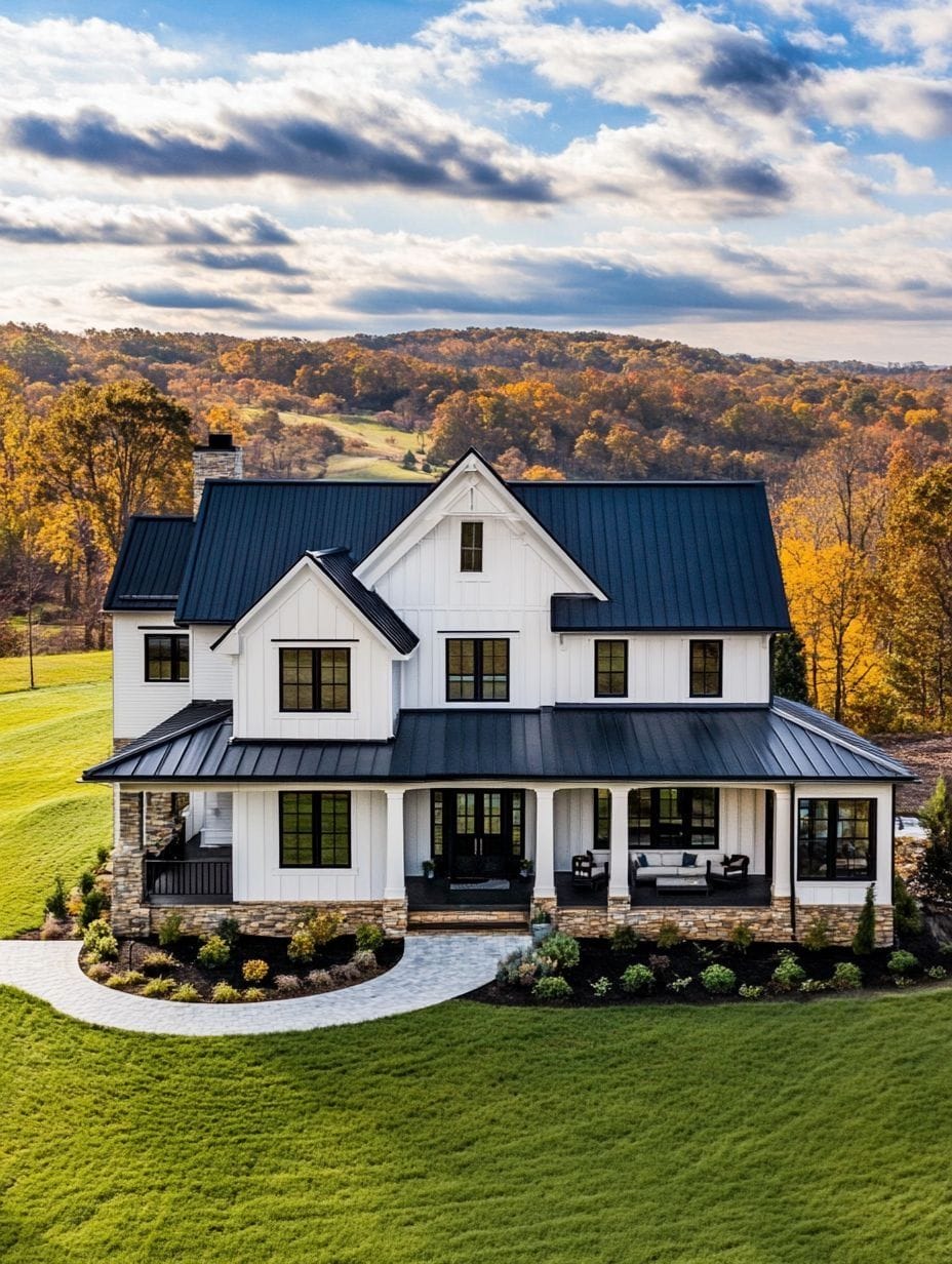 A modern farmhouse with white siding, black roof, and large front porch is set on a grassy lawn with trees and rolling hills in the background.